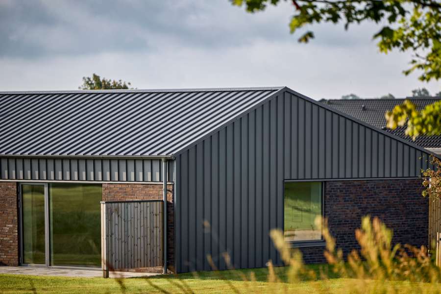 Past and future meet in steel-clad terraced houses with history in the backyard, Jernaldervej 8, 8600 Silkeborg, Denmark